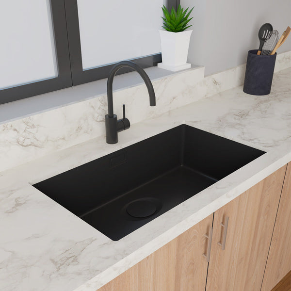 Stylish granite sink with a single bowl and waste overflow, designed for modern kitchens with a black finish.