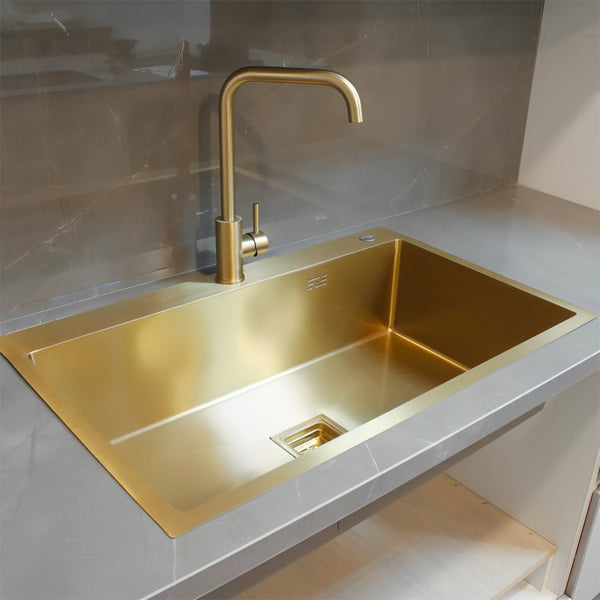 Luxurious gold-plated kitchen sink with waste fitting and practical design for enhanced functionality